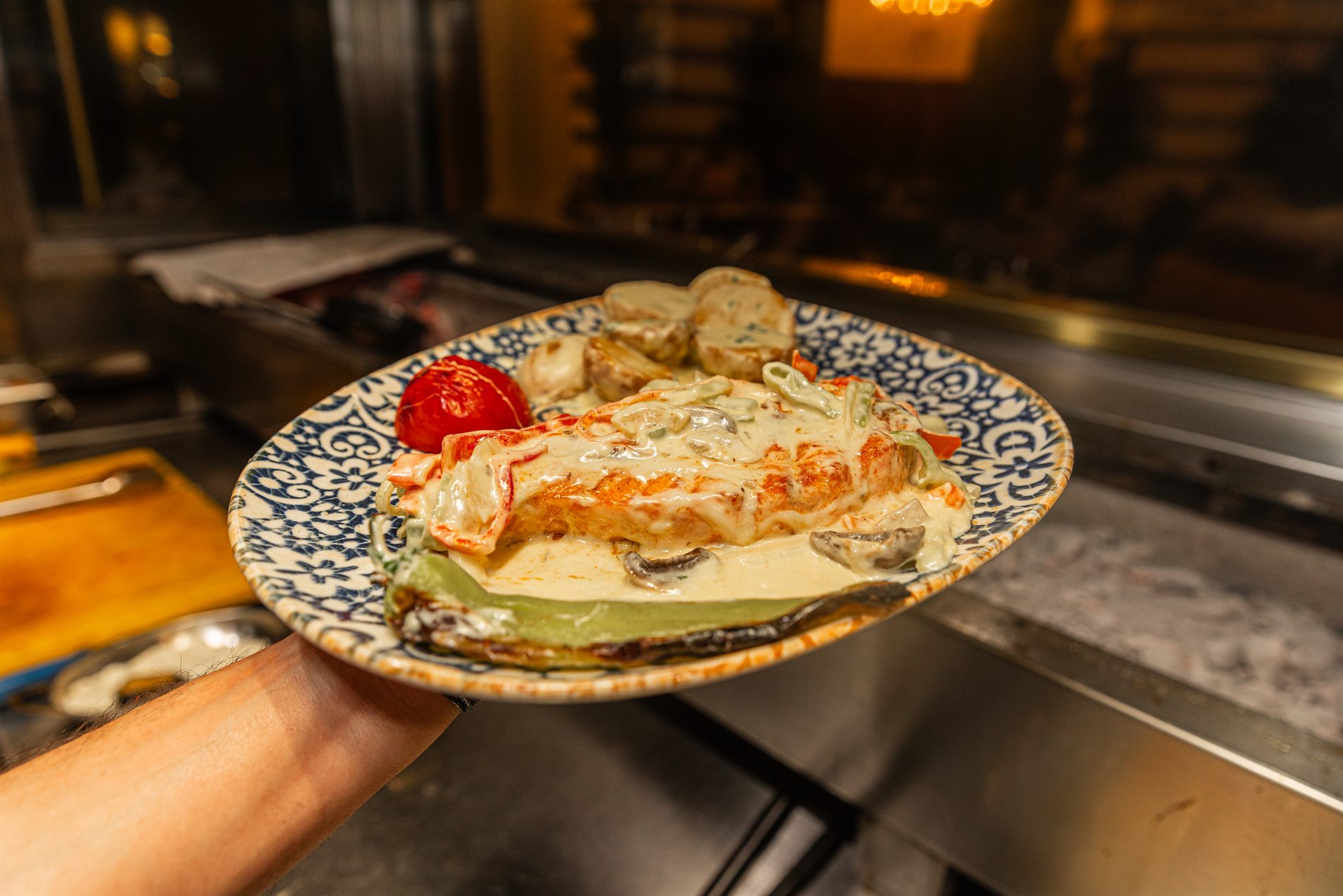 A dish being finished at the pass