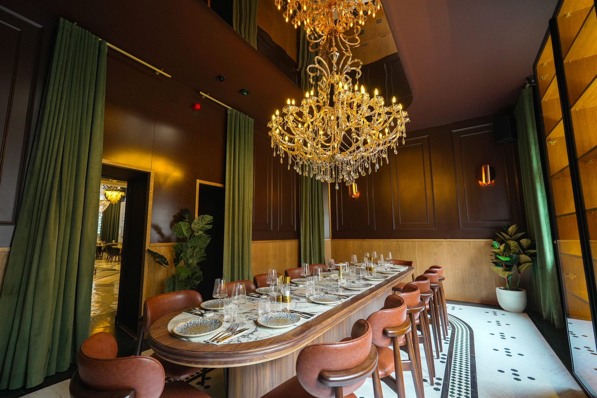 Gold chandeliers above the long marble table in the private room at Elif