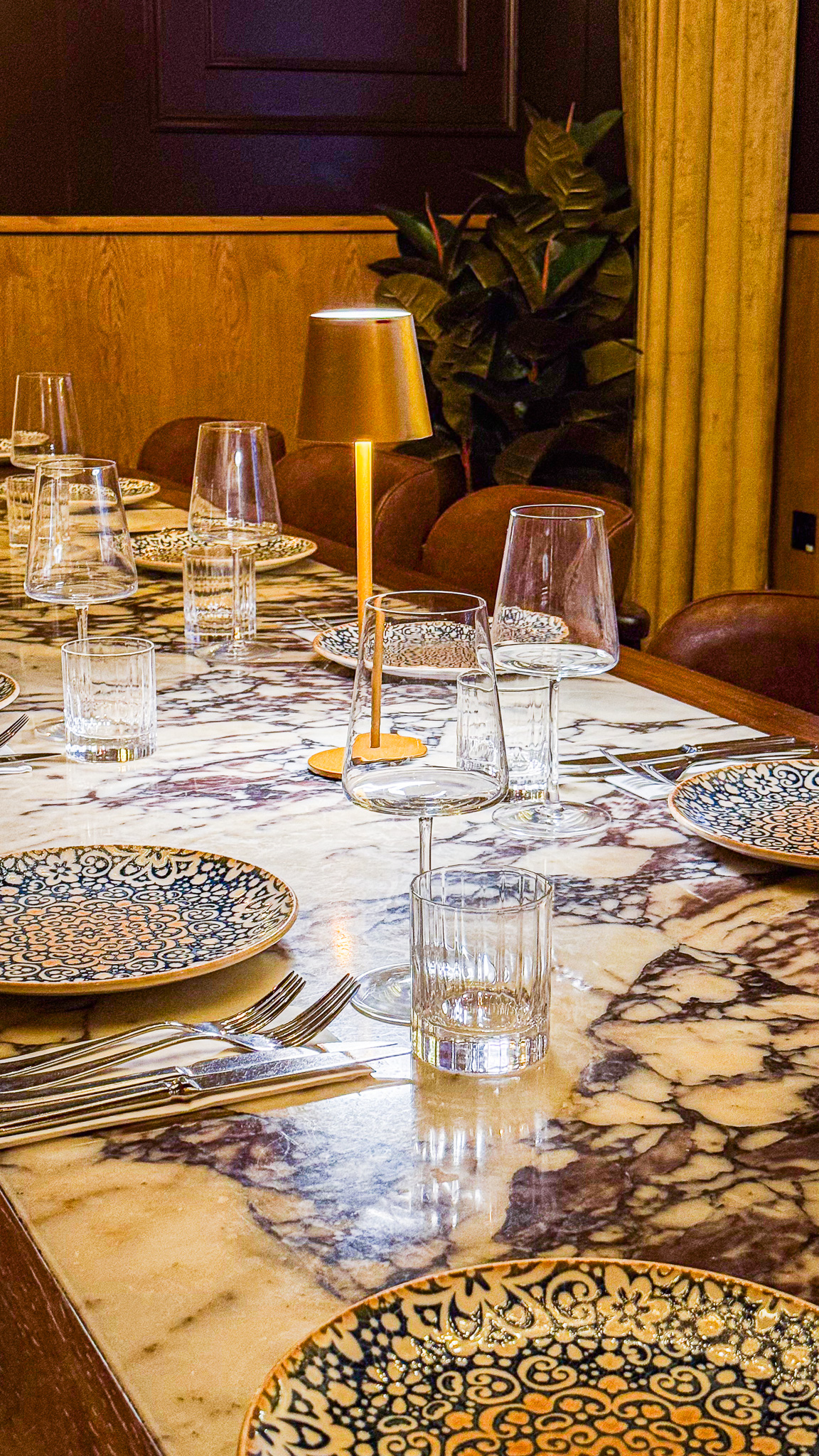 The private dining table by candlelight, with marble and patterned plates