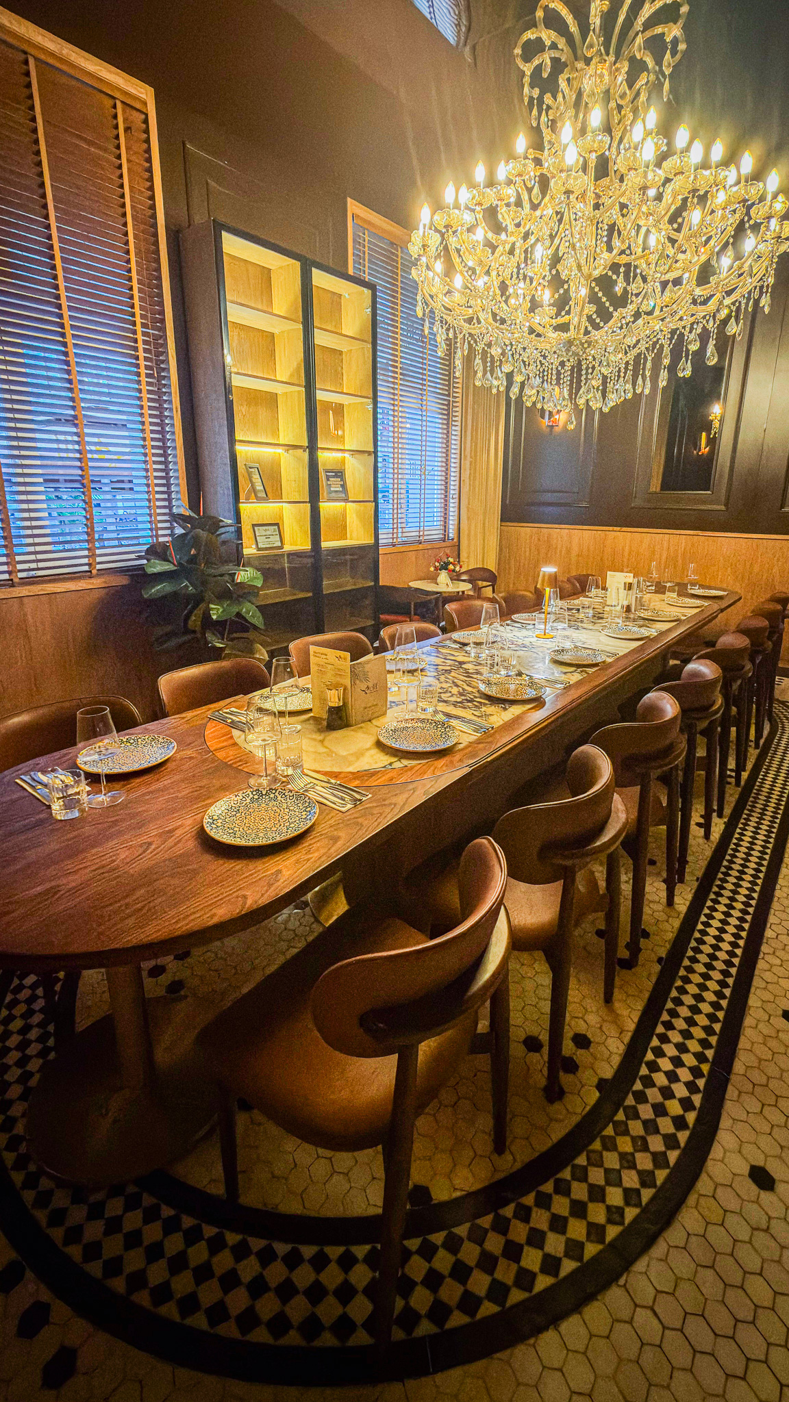 The private dining room at Elif, with a long table beneath a crystal chandelier